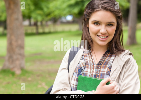 Portrait of a first-year student holding a textbook Stock Photo - Alamy