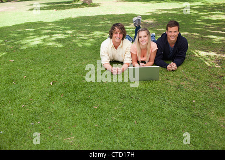 Three smiling students looking at camera Stock Photo