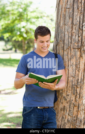 Muscled young man reading a book Stock Photo - Alamy