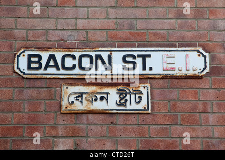 Bacon Street, sign in English and Bengali in the London Borough of Tower Hamlets, near Brick Lane London, England, UK. Stock Photo