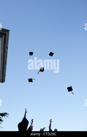 Grad students throwing their hats in the sky Stock Photo