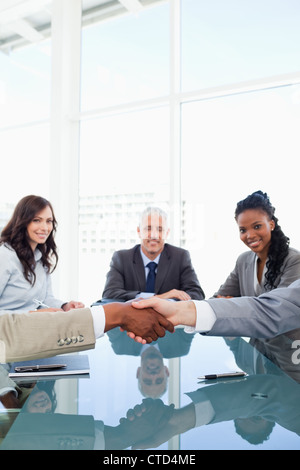 Handshake between two employees during a meeting Stock Photo