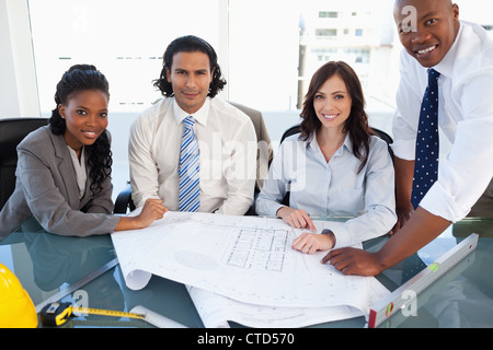 Smiling business team working on a project in a meeting room Stock Photo