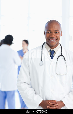 Young doctor wearing a tie under his white lab coat Stock Photo