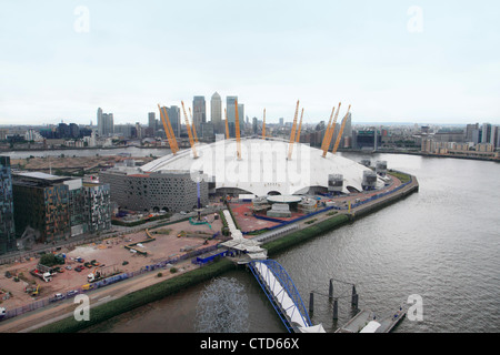 Aerial of O2 Arena on Greenwich Peninsula with Canary Wharf in background, London UK