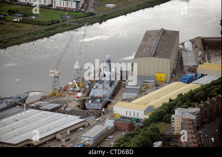 BAE Systems, Glasgow on the River Clyde, with warship in dock. Stock Photo