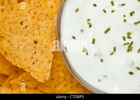 Close up of a bowl of white dip  beside nachos Stock Photo