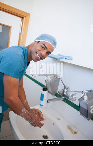 Happy male surgeon washing his hands Stock Photo