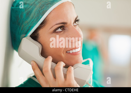 Female surgeon on the phone in a hallway Stock Photo