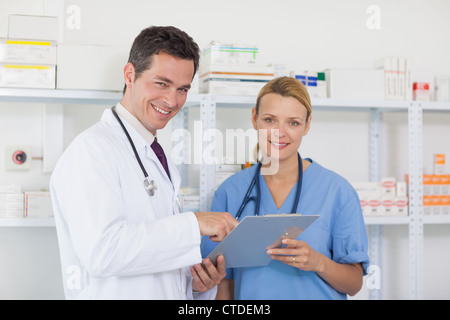 Smiling pharmacist with a nurse in a pharmacy Stock Photo
