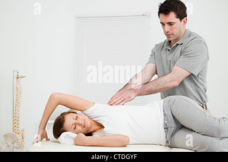 Serious doctor using his fingertips on a patient Stock Photo
