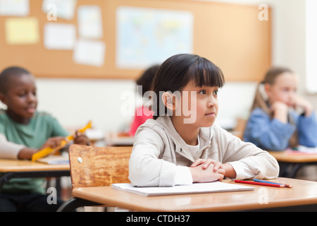 Student listening to her teacher Stock Photo