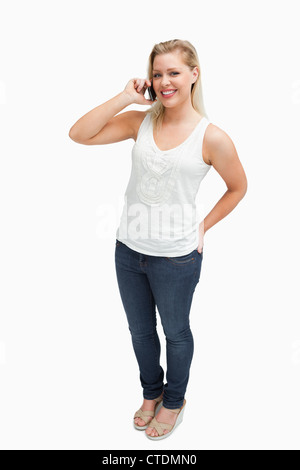 Cheerful blonde woman holding her cellphone Stock Photo