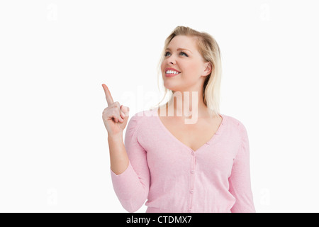 Smiling woman pointing at a blank space Stock Photo