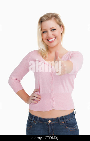 Smiling woman posing while putting her thumbs up Stock Photo - Alamy