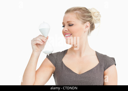 Woman looking a hourglass Stock Photo