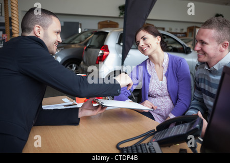 Salesman talking to a couple Stock Photo