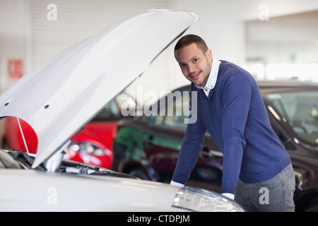 Man leaning over a car Stock Photo