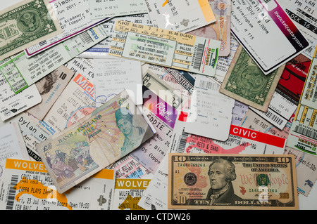 A pile of concert tickets, plane tickets and money Stock Photo