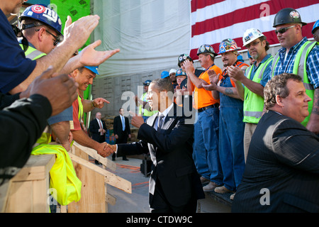 US President Barack Obama and New Jersey Governor Chis Christie, right, greet workers during a tour of the One World Trade Center site June 14, 2012 in New York, NY. Stock Photo