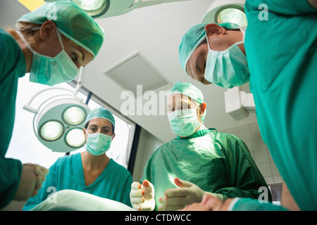 Surgical team working on a bleeding patient Stock Photo