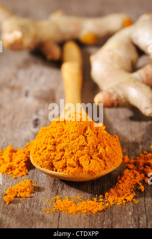 turmeric powder in wooden spoon Stock Photo