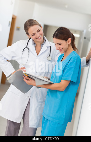 Smiling nurse and a doctor looking in a file Stock Photo