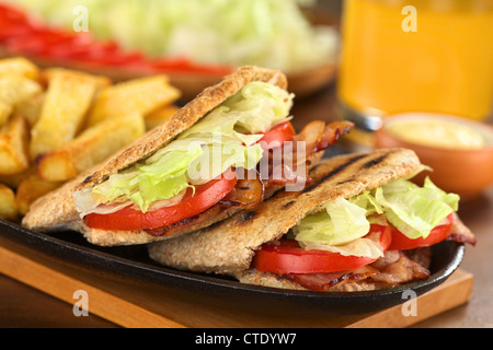 BLT (bacon, lettuce, tomato) wholewheat pita sandwich with French fries Stock Photo