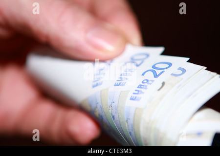part of a hand holding euro notes Stock Photo