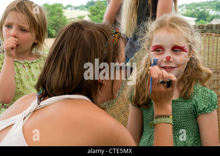 Girl having her face painted at a party