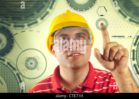 Construction worker pressing the button on touch screen display Stock Photo