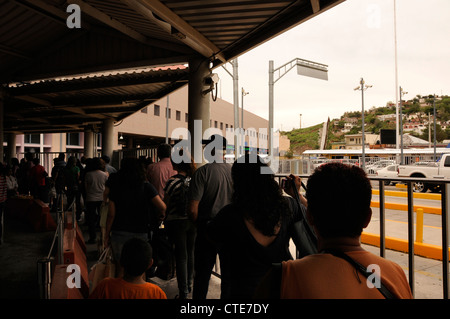 Border crossers wait in Nogales, Sonora, Mexico, to pass through customs to enter the United States at Nogales, Arizona. Stock Photo