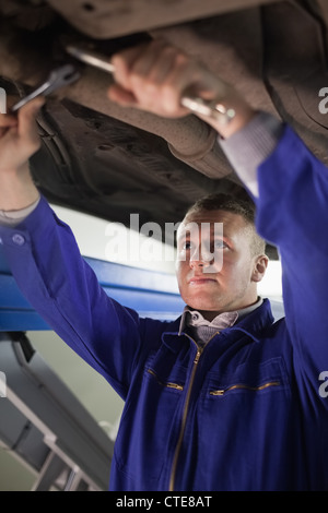 Concentrated mechanic repairing with tools Stock Photo