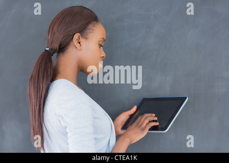 Side view of a woman using a tablet computer Stock Photo