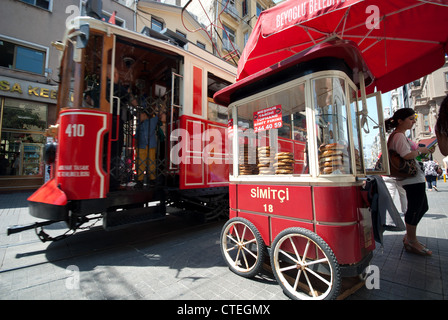 ISTANBUL, TURKEY. A simit stand and tram on Istiklal Caddesi in the Beyoglu district of the city. 2012. Stock Photo