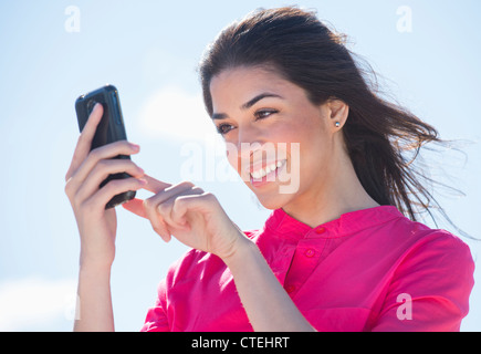 Young woman using PDA Stock Photo