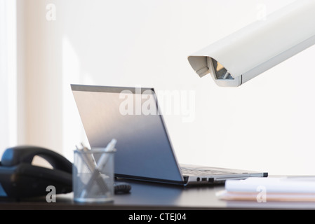 Cctv camera over laptop Stock Photo