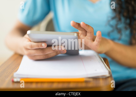 Midsection of girl (12-13) using tablet pc Stock Photo
