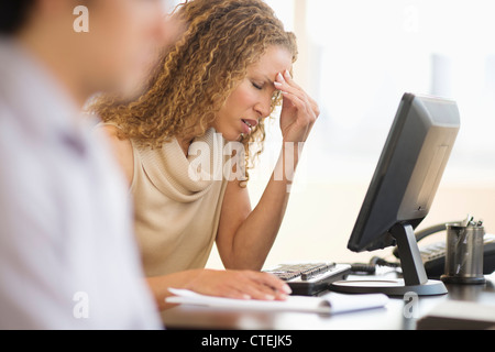 USA, New Jersey, Jersey City, Business woman having headache in office Stock Photo