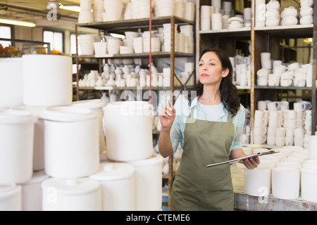 USA, New Jersey, Jersey City, Woman with checklist in pottery warehouse Stock Photo