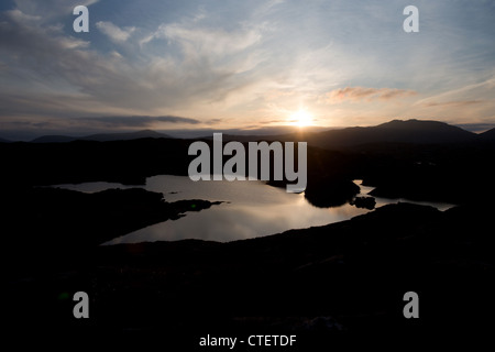 Isle of Harris, Scotland. Silhouetted sunset view of Loch Udromuil on Harris’s east coast. Stock Photo