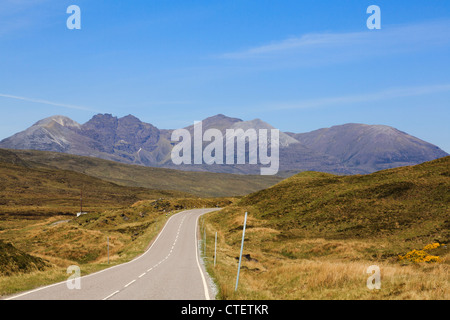 An empty country road heading towards An Teallach mountain massif in stunning northwest Scottish Highlands. Ross and Cromarty Highland Scotland UK Stock Photo