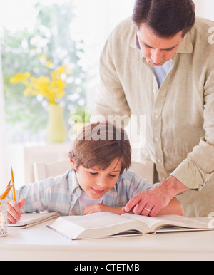 USA, New Jersey, Jersey City, Father helping son (10-11 years) with his homework Stock Photo