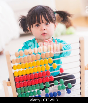 USA, New Jersey, Jersey City, Portrait of baby girl (12-17 months) playing with abacus Stock Photo