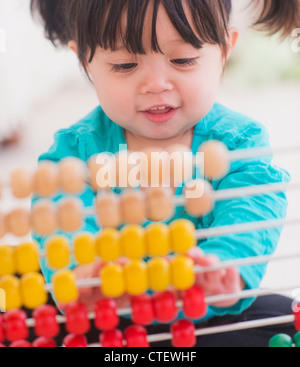 USA, New Jersey, Jersey City, Portrait of baby girl (12-17 months) playing with abacus Stock Photo