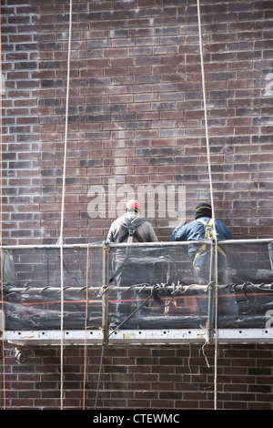 USA, New York, New York City, Construction workers on scaffolding Stock Photo