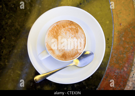 cup of cappuccino on stone table in outdoor cafe Stock Photo