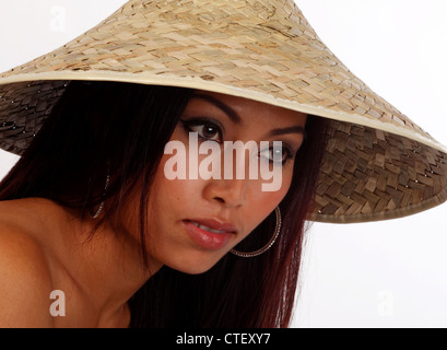 Oriental woman in a coolie hat Stock Photo