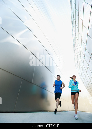 USA, California, Los Angeles, Young couple jogging in city Stock Photo