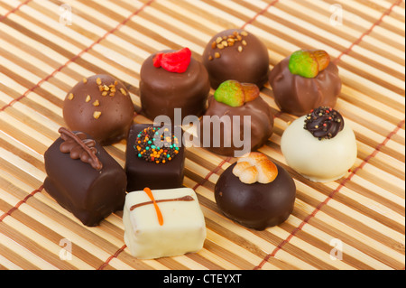 Set different chocolates on bamboo background Stock Photo